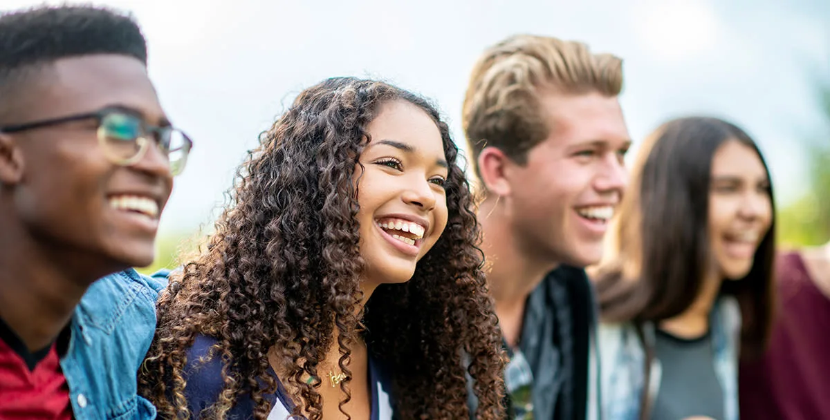 A group of happy teenagers laughing