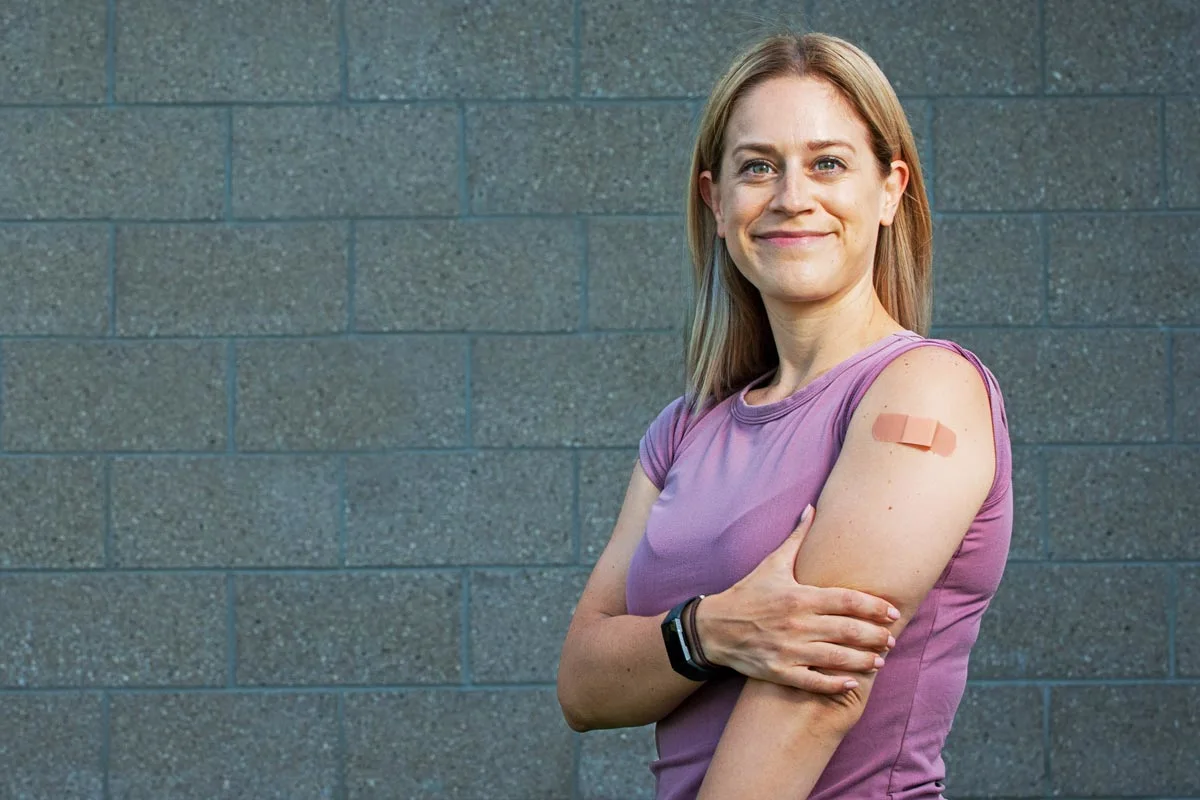 Woman with vaccination bandage on her arm