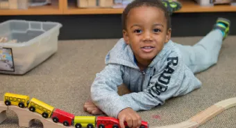 child playing with a toy train