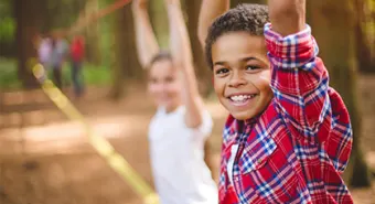 boy hanging from ropes