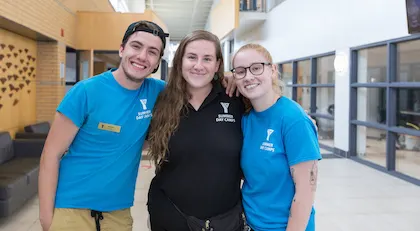 children posing for picture with YMCA staff