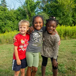 Campers smiling and using binoculars