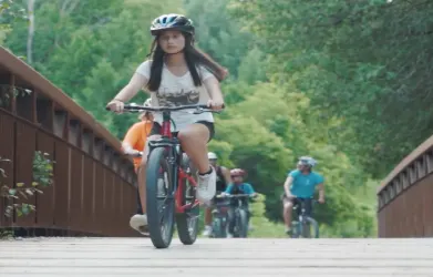 several boys and girls riding their bikes