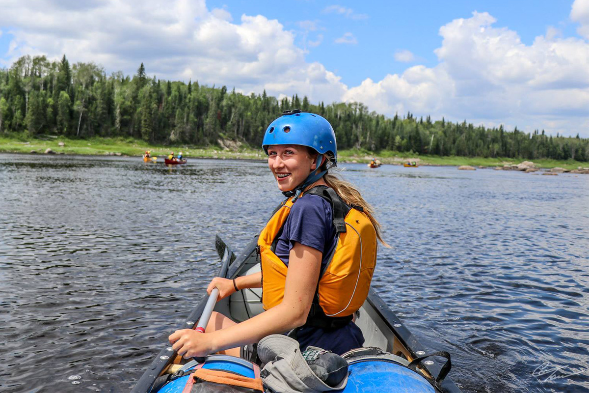 girl in bow looking back smiling