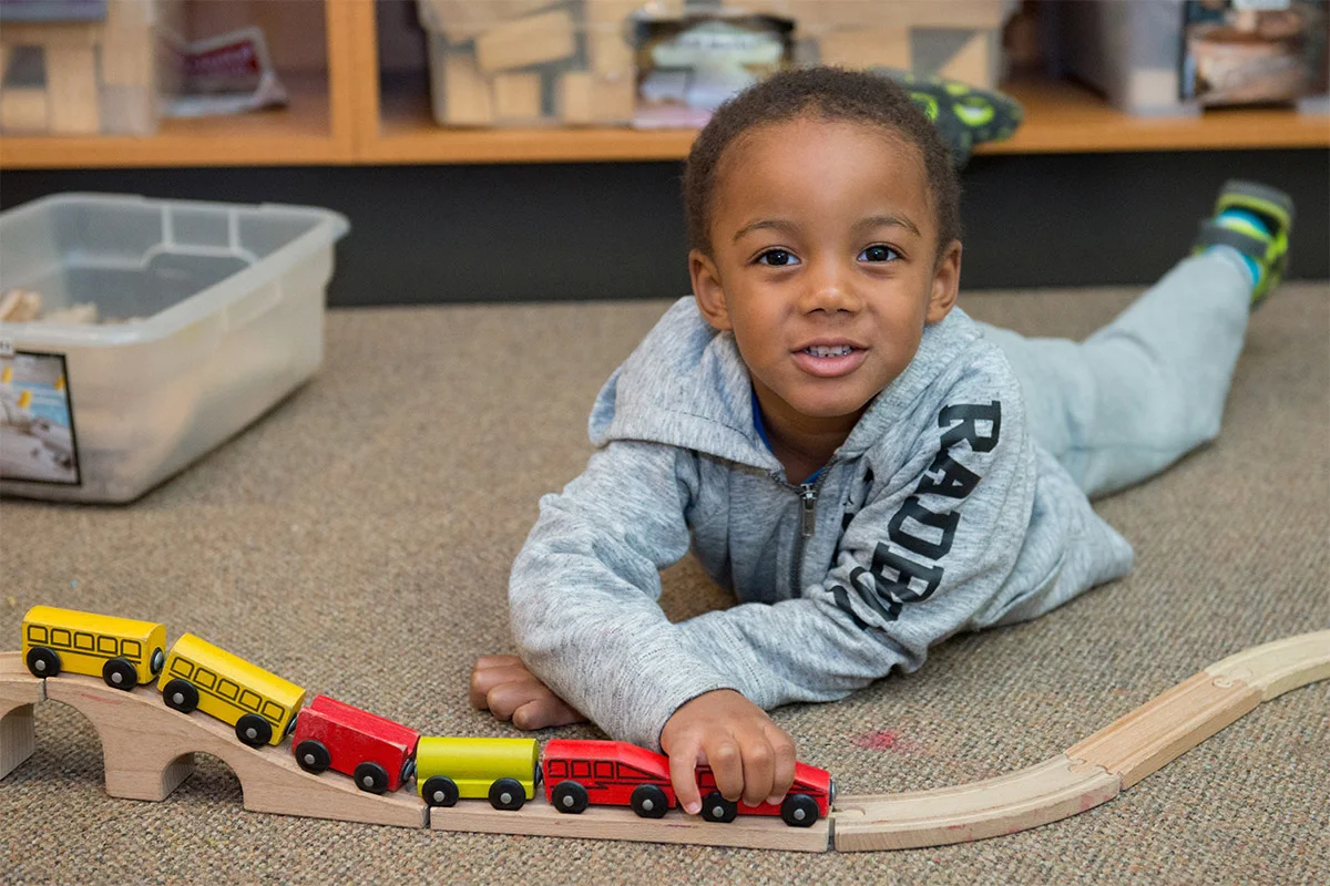 Little boy playing with train