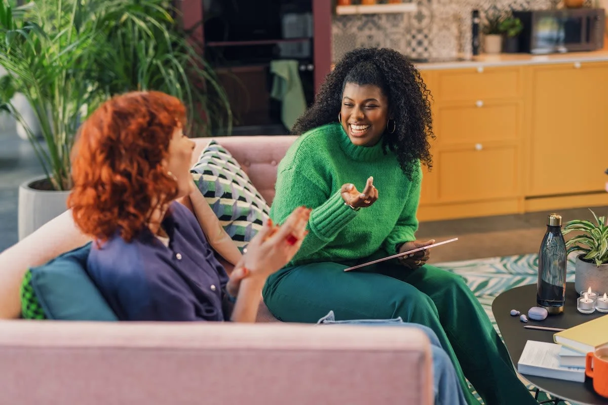 two women sitting on the couch