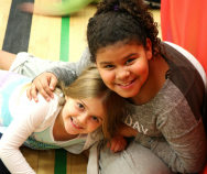 Mia and Elizabeth hugging in the gym