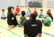 Camp leaders explain new activity to group of campers