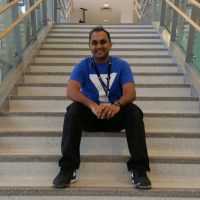 Roshan sitting on the steps at Cooper Koo YMCA