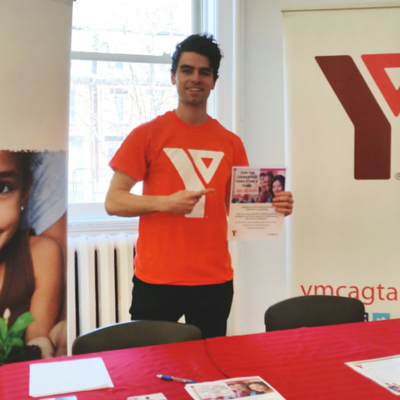 Michael holds up a Cooper Koo Family YMCA flyer