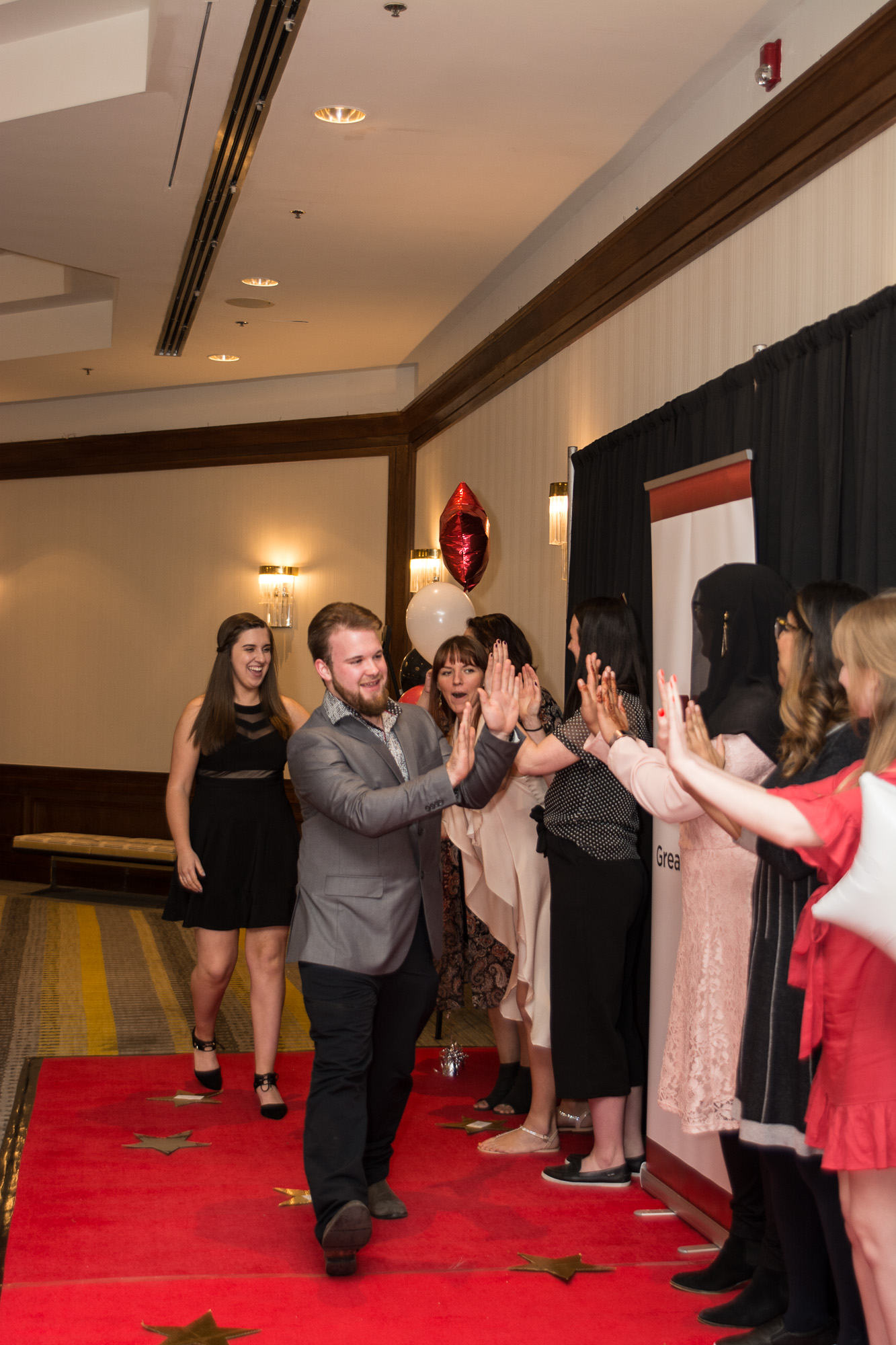 Brian giving high fives to staff members