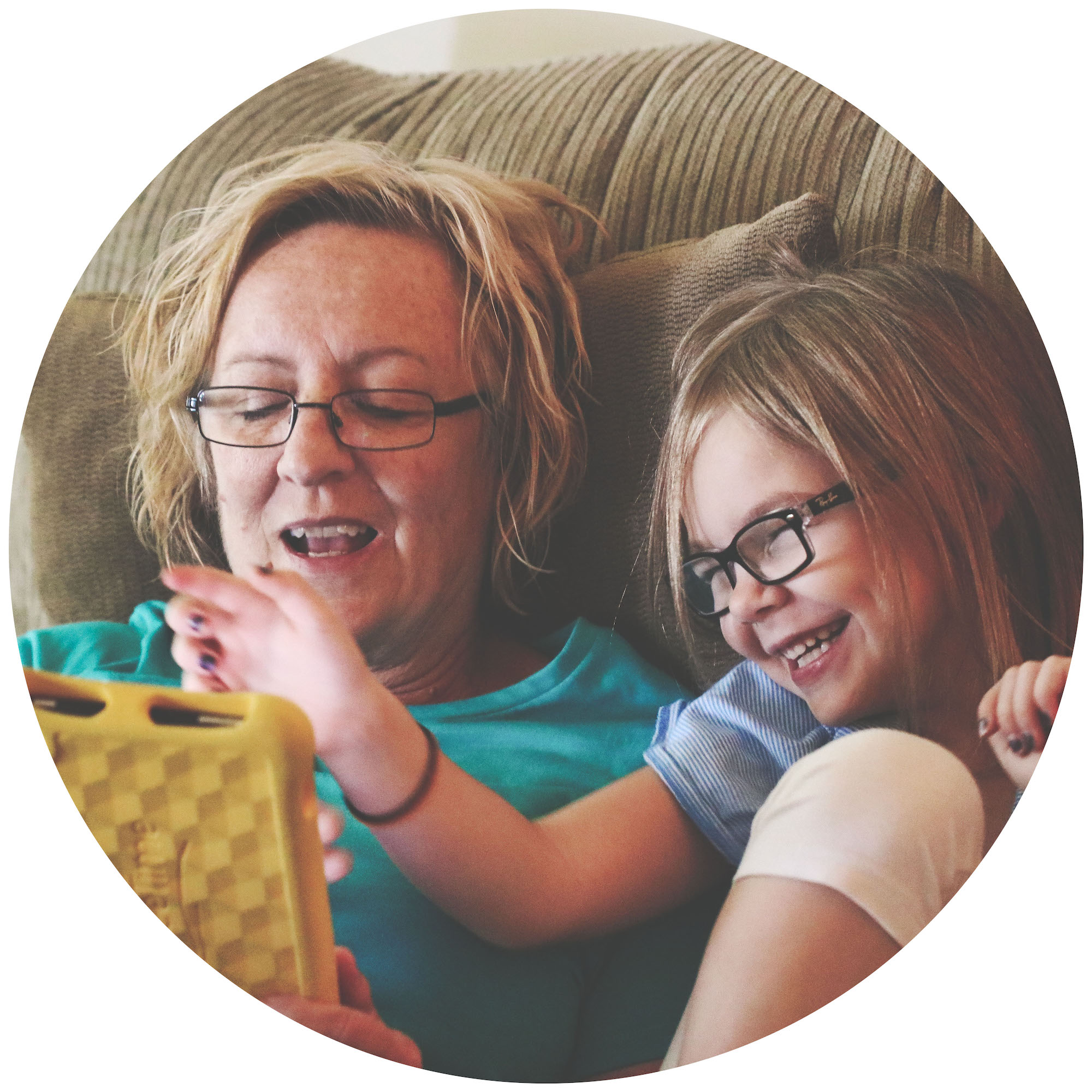 Grandmother and daughter playing on tablet