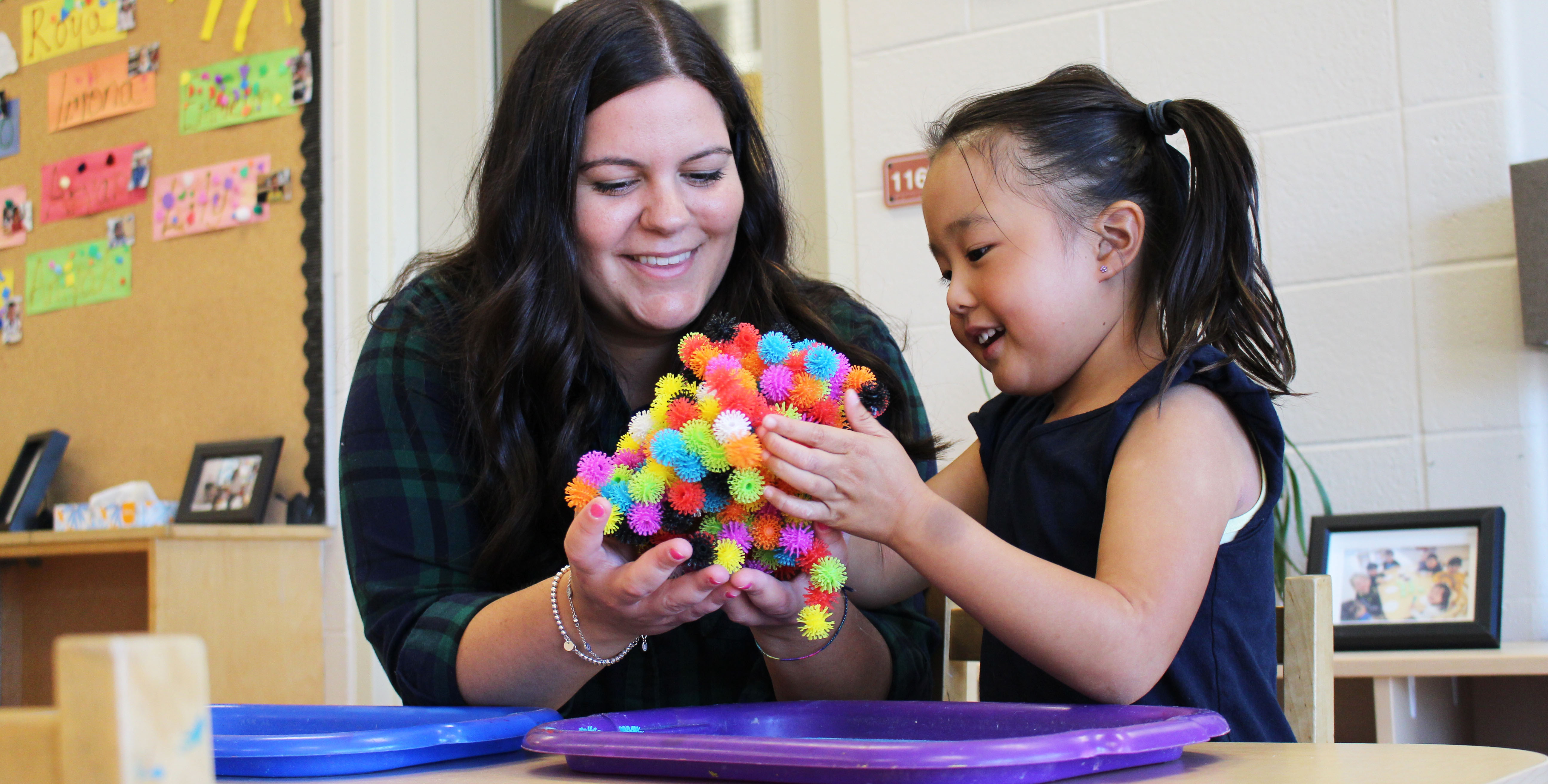 Educator and Child playing with toy