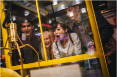 Group of friends playing at claw machine