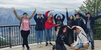 Group of youth posing in front of mountain scenery