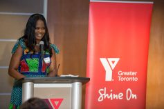 Omoteniola Swodumila speaks at the podium after receiving the 2023 Outstanding Black Achiever of the Year Award.